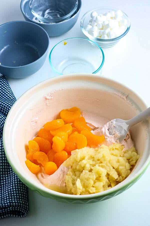 oranges and pineapple added to fluff salad