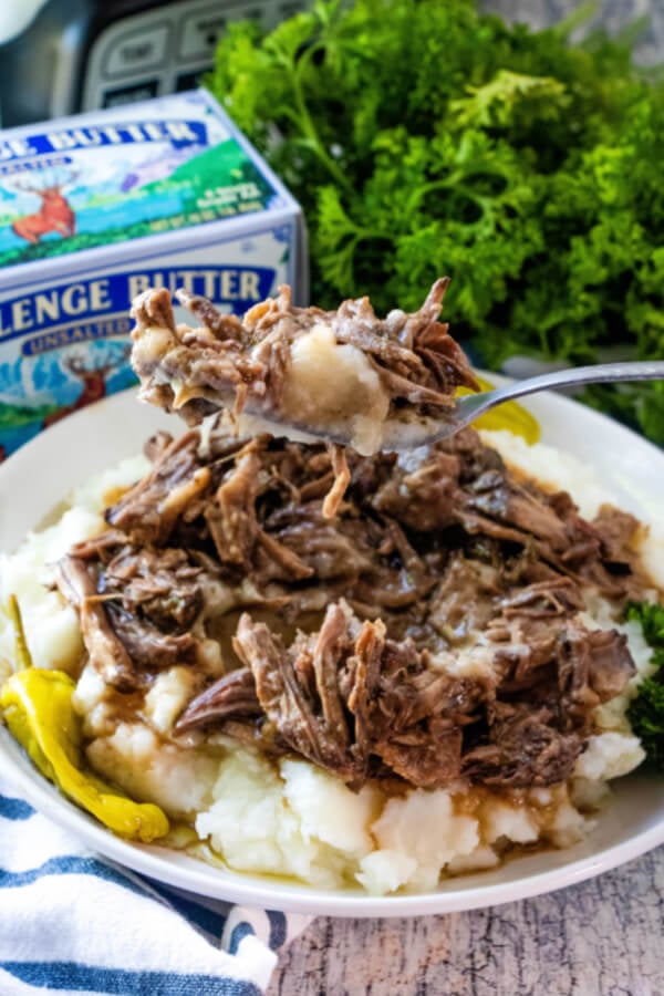 forkful of shredded beef with mashed potatoes