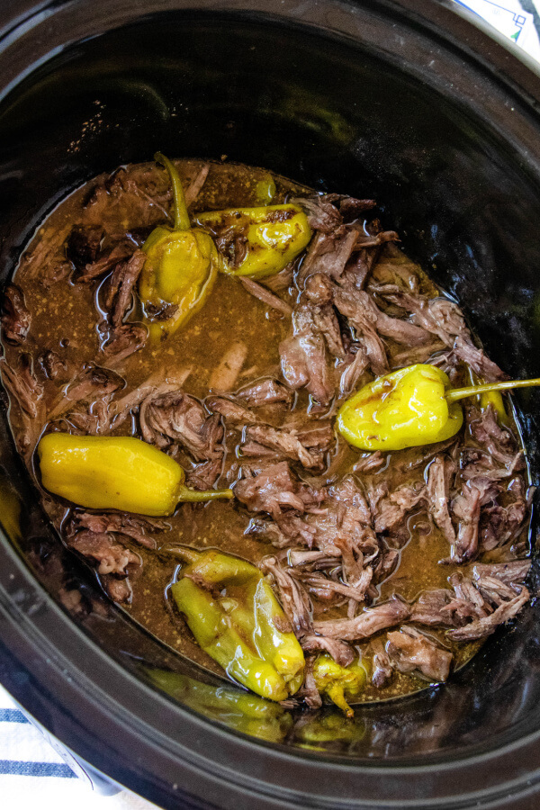 shredded pot roast in slow cooker with peppers