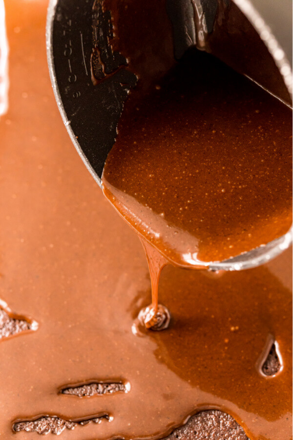 frosting being poured over cake