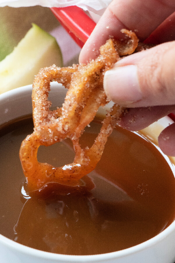 fries being dipped into caramel sauce