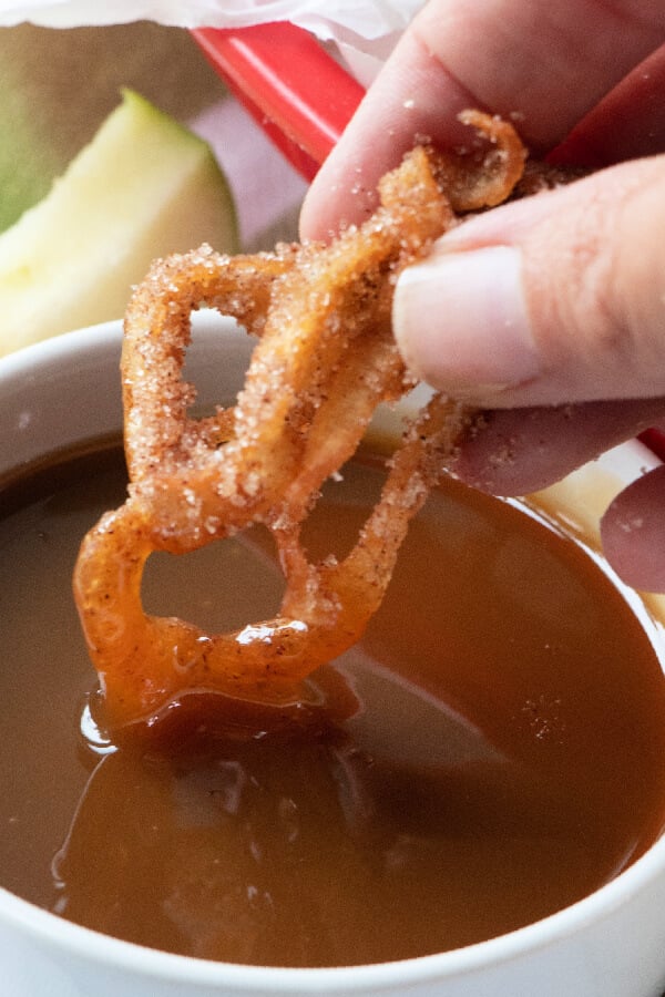 fries being dipped into caramel sauce