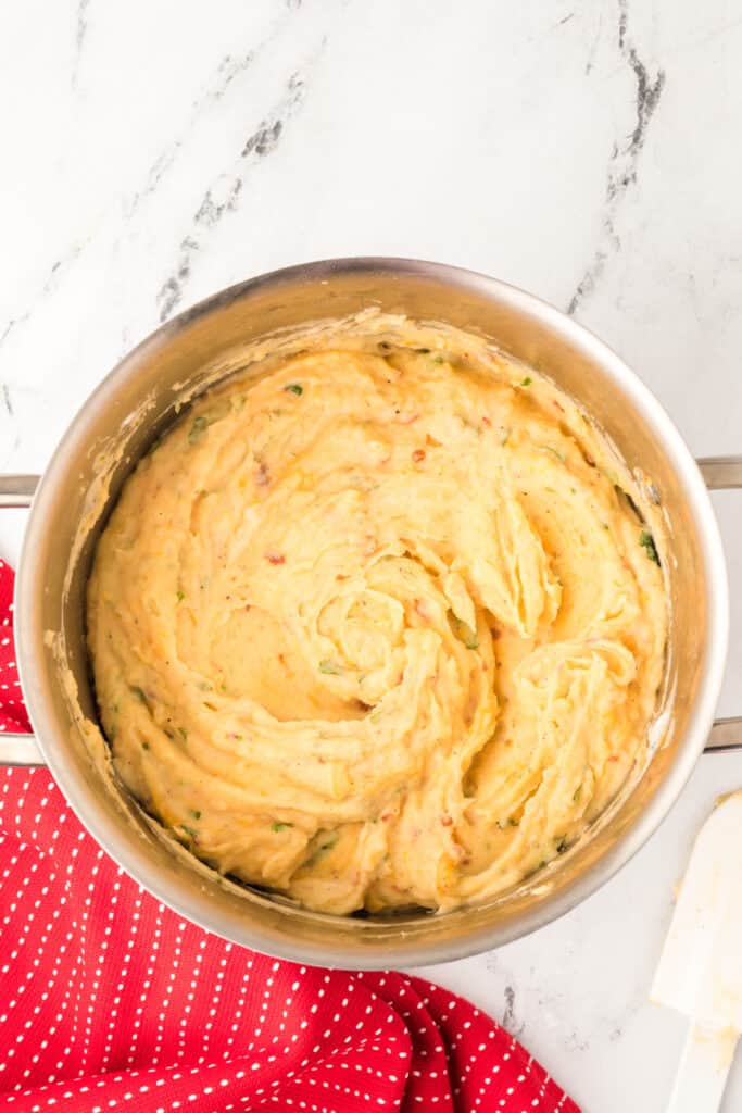 Chipotle Cheddar mashed potatoes mixed together in a pot