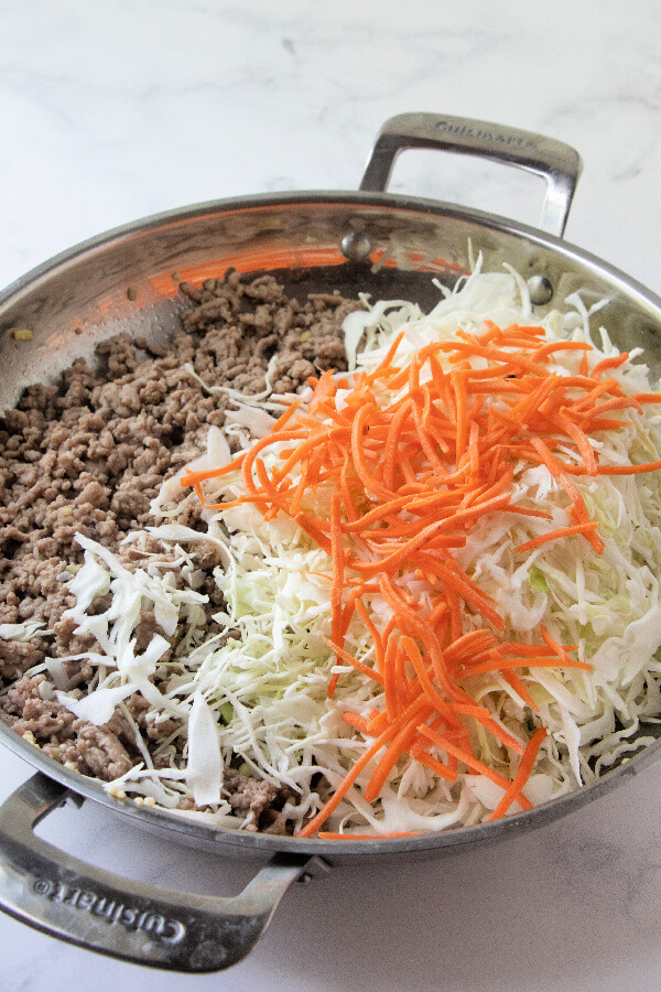 adding cabbage and carrots