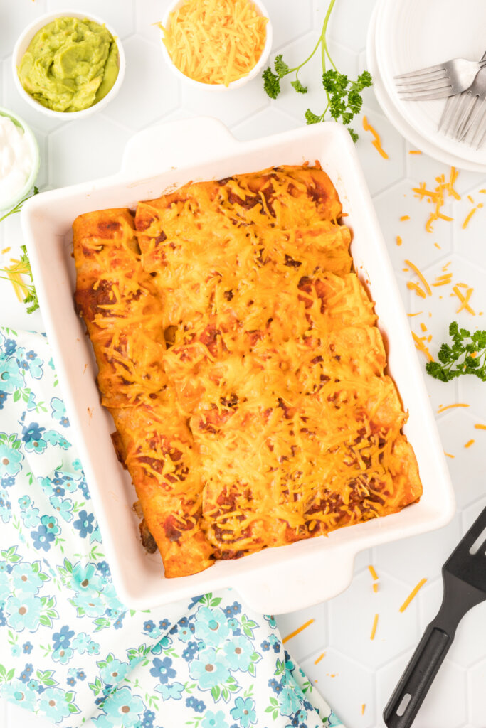 finished ground beef enchiladas in a casserole dish