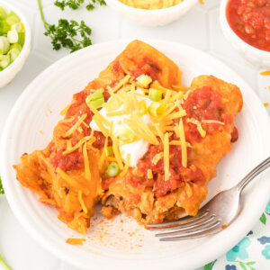 two ground beef enchiladas on a serving plate