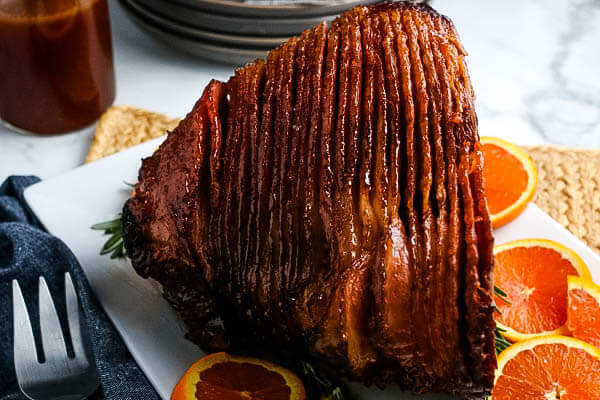 closeup of spiral baked ham on platter