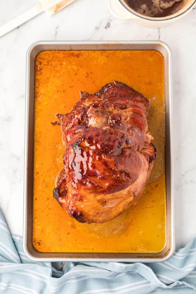 Carefully pour half of the glaze over the ham. Place the ham, uncovered, under the broiler. Watch it closely and broil for 1-2 minutes or until the glaze starts to bubble.