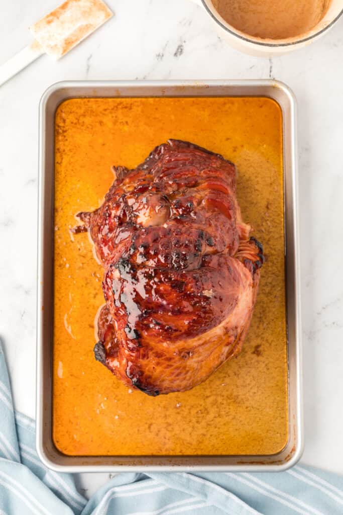 Remove the ham from the oven and pour the remaining glaze over the ham. Return the ham to the oven, uncovered, and continue to broil for 1-2 minutes.
