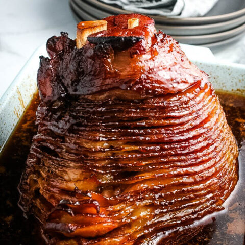glazed ham in baking liquid in pan