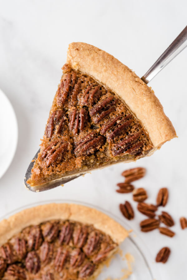 slice of maple pecan pie on pie server