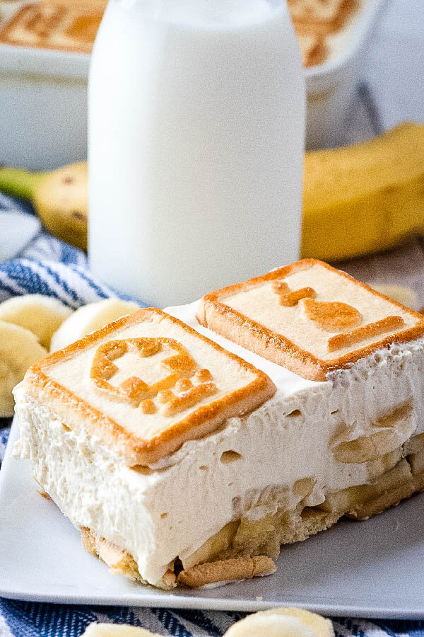 paula deen's banana pudding on plate with glass of milk in background