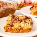 Square image of Pumpkin Dump Cake with a creamy pumpkin layer and pecan topping