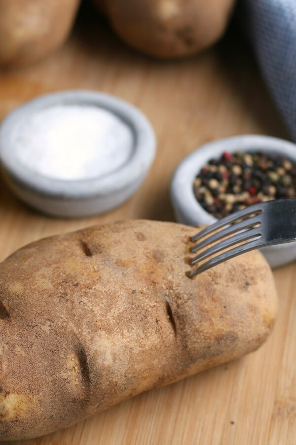 poking a fork into a potato