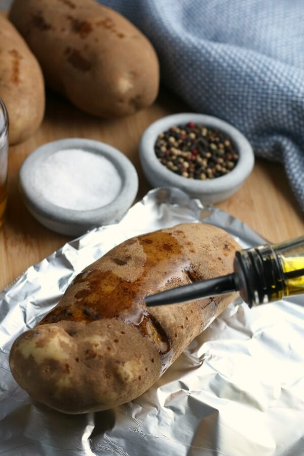 covering the potato with oil