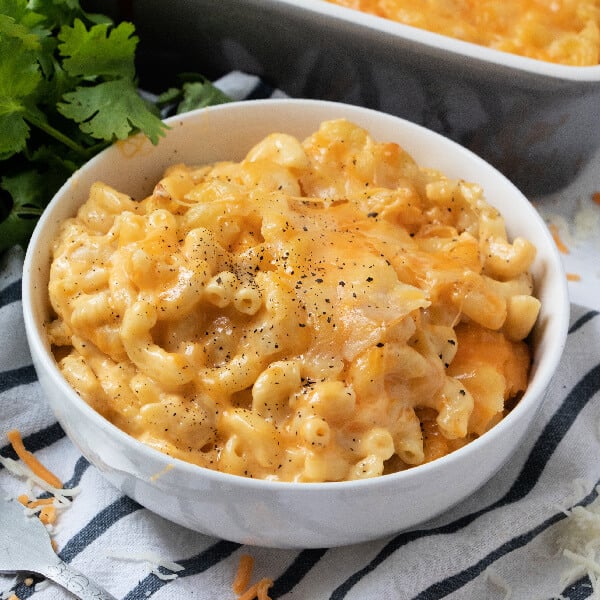 white bowl with scoop of southern baked mac and cheese