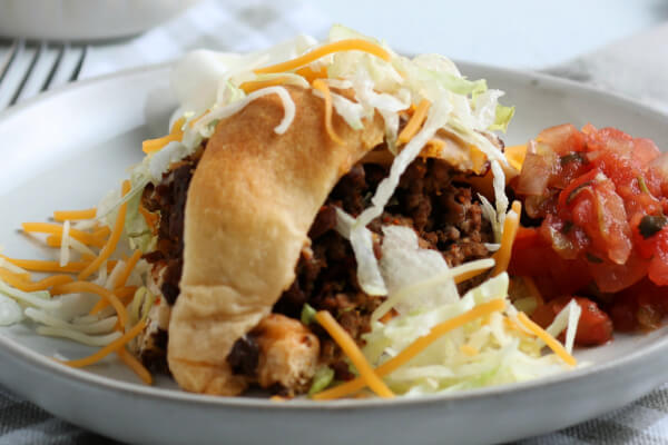 slice of taco ring with shredded lettuce cheese and salsa