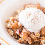 apple crumble in bowl with ice cream
