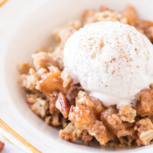 closeup apple crumble in bowl with ice cream