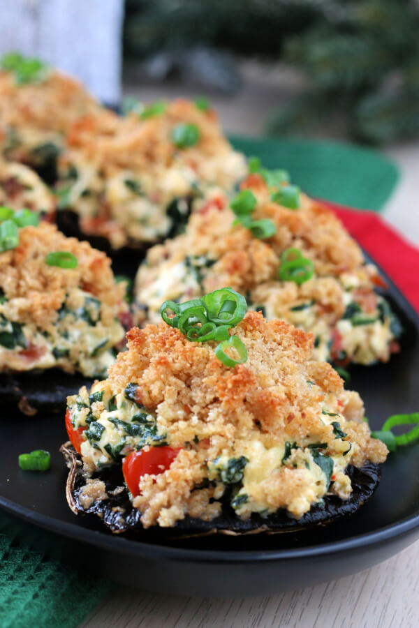 stuffed mushrooms on black plate ready to be served