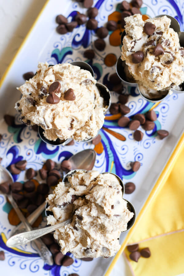 looking down onto metal bowls with edible cookie dough in them