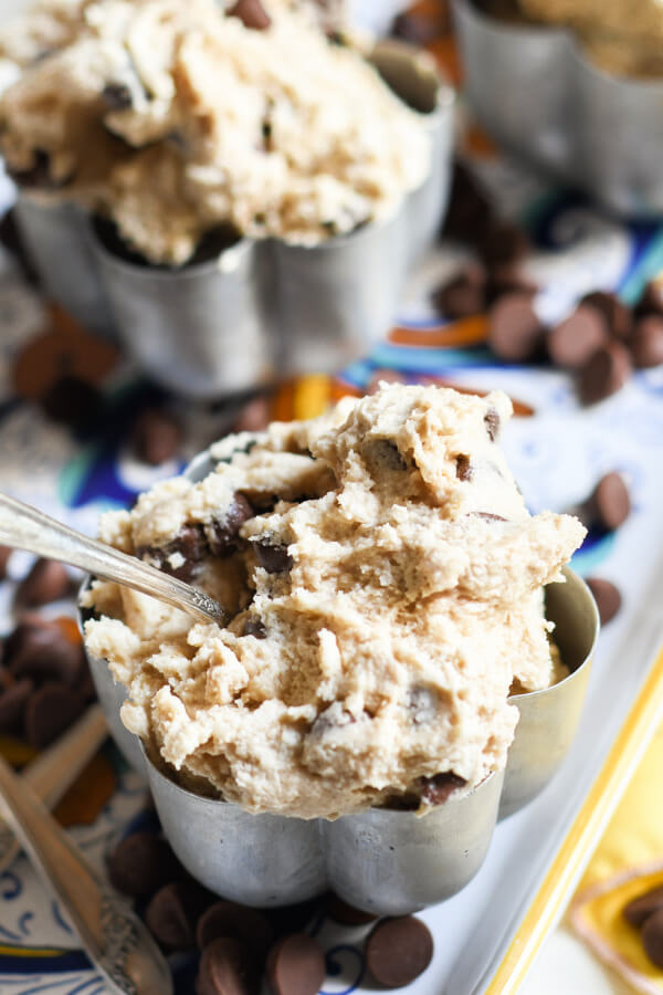 edible cookie dough in metal bowl with spoon off to the side