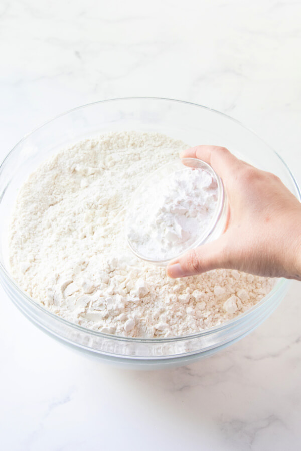 adding baking powder to flour