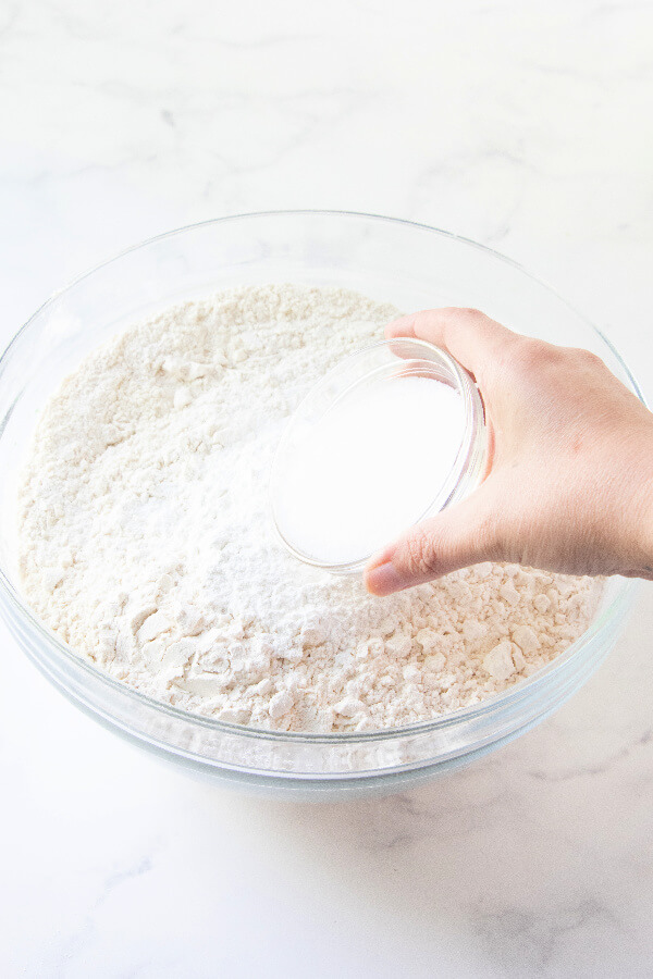 adding sugar to the flour mixture