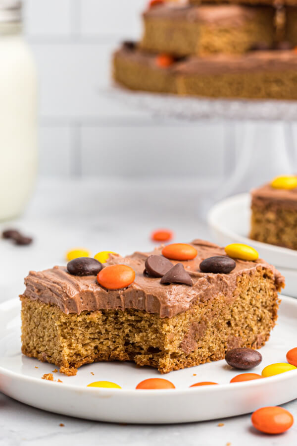 frosted peanut butter cookie bar on white plate with candies