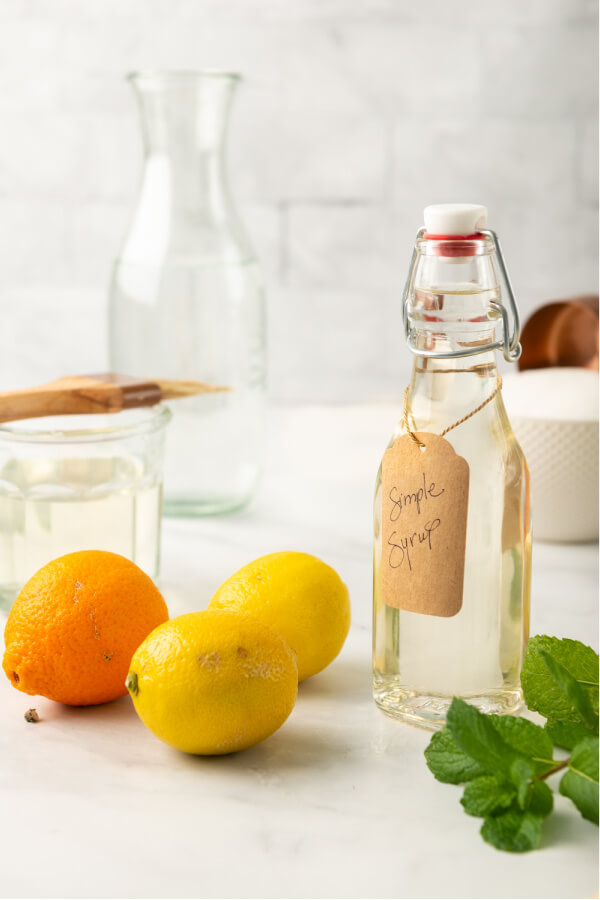 citrus and mint with a bottle of simple syrup