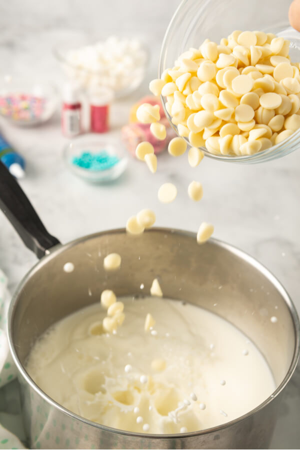 adding white chocolate to milk in pan