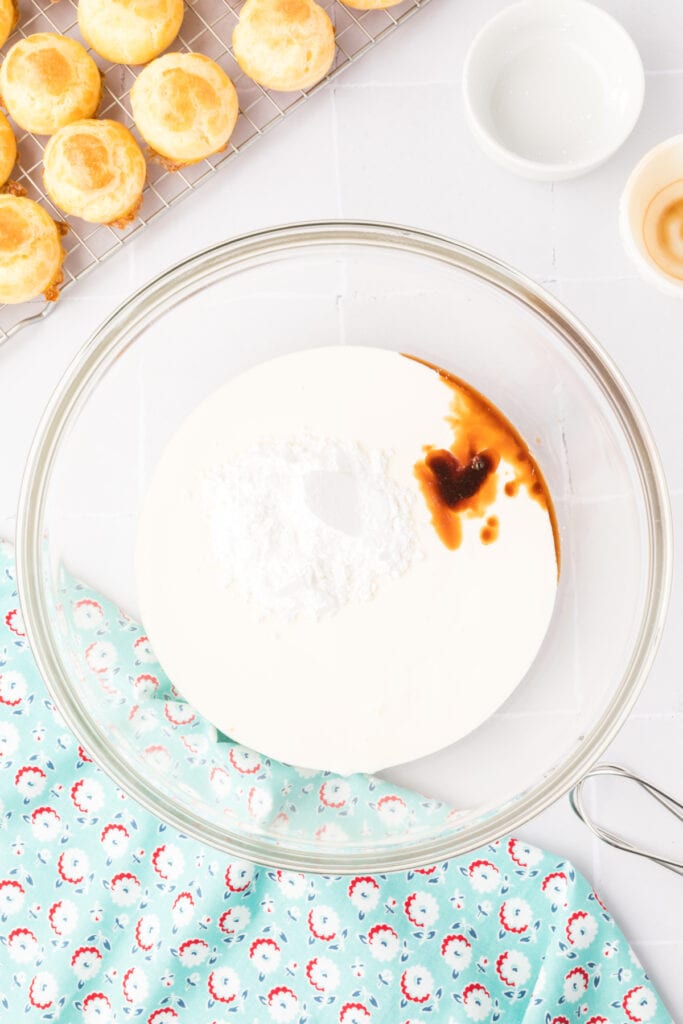 In a large bowl, combine heavy cream, vanilla extract, and powdered sugar.