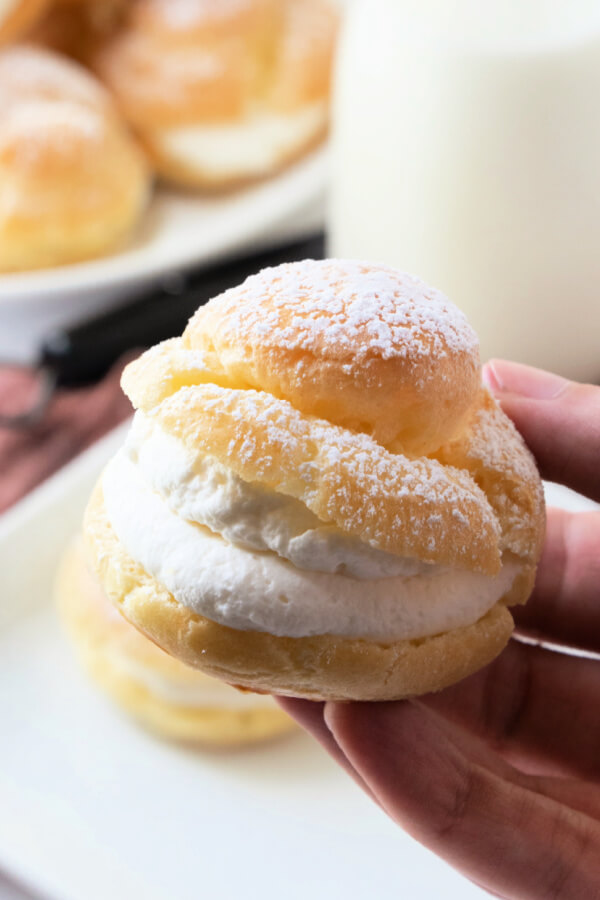 hand holding cream puff