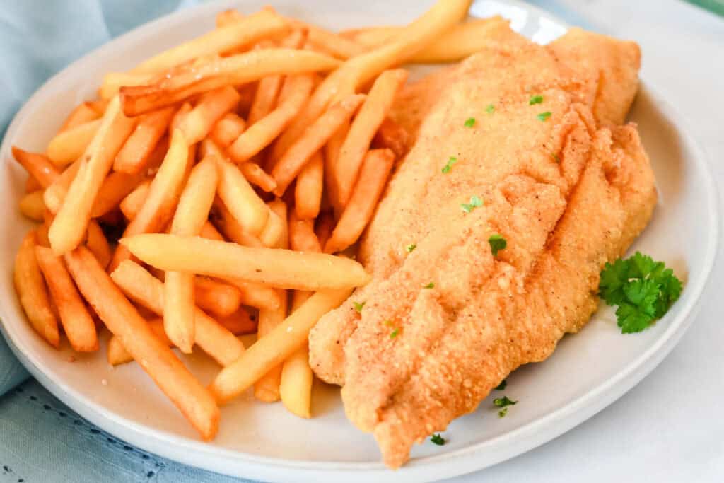 Golden cornmeal fried fish fillets served with crispy French fries
