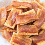 bacon crackers in a bowl lined with parchment paper