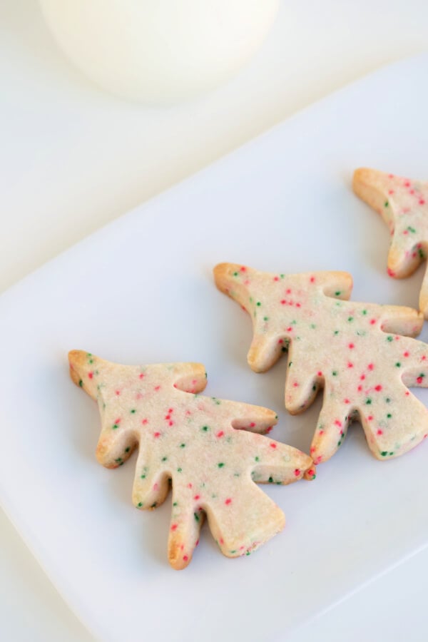 closeup of tree-shaped shortbread cookies on white plate