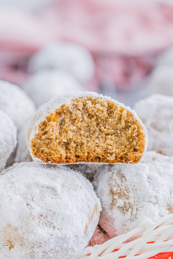 Gingerbread Pecan Snowballs stacked in holiday basket