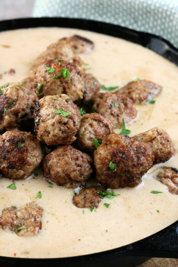 cooked Swedish meatballs in a pan of gravy