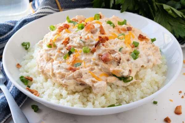 bacon cheddar ranch chicken over cauliflower rice in bowl