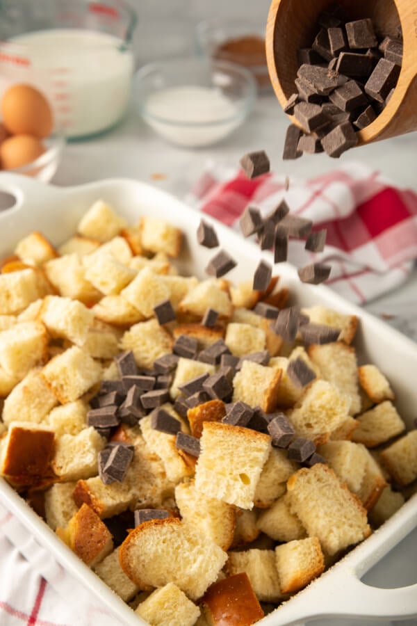 combining the chocolate chips and bread cubes in a casserole dish