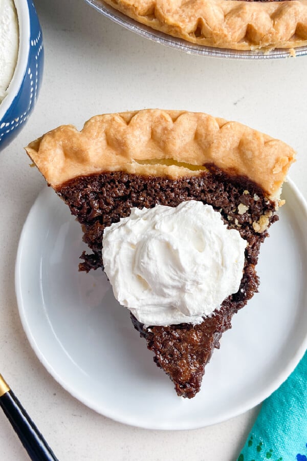 looking down on a slice of chocolate chess pie with whipped cream on top