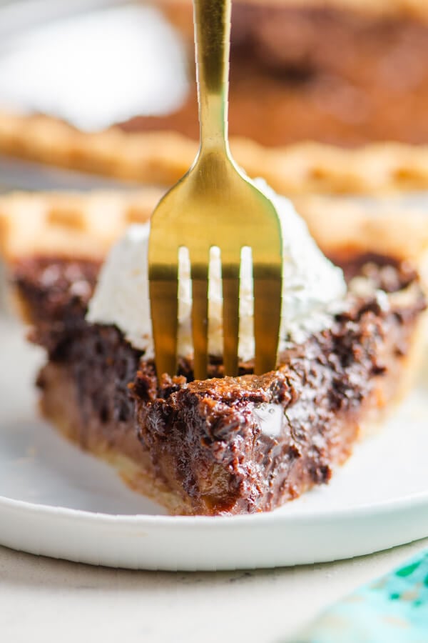 a fork taking off a bite of pie from the slice