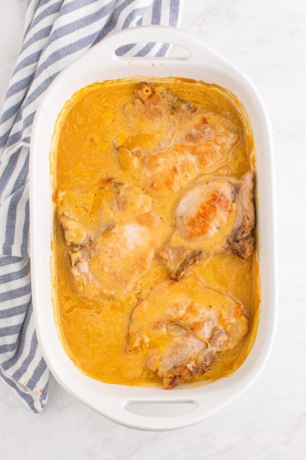 casserole dish with pork chops in gravy