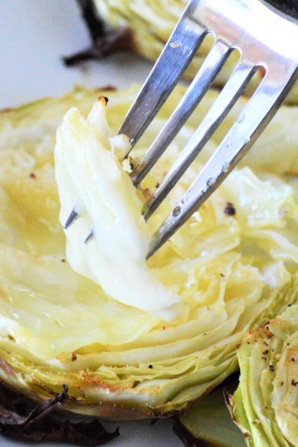 garlic butter roasted cabbage with fork