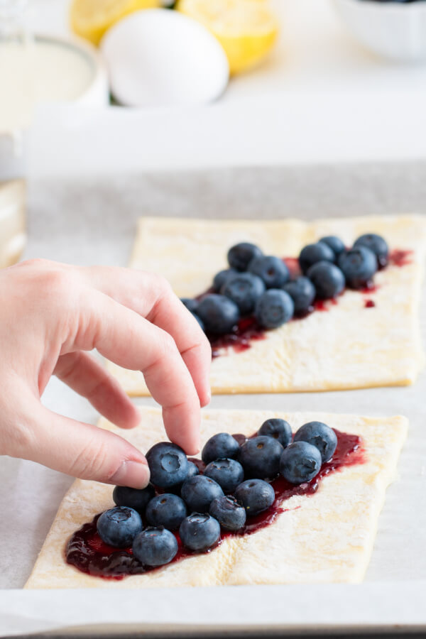 fresh blueberries put on the dough squares