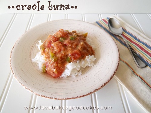 Creole tuna on a white plate with a spoon.