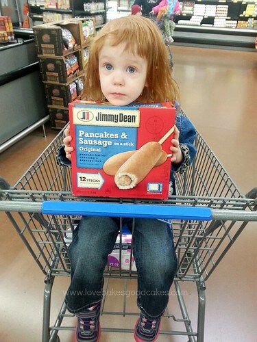 Homemade Vanilla Syrup with Jimmy Dean Pancakes & Sausage on a stick. A girl holding a package of Jimmy Dean Pancake & Sausage on a stick original flavor box.