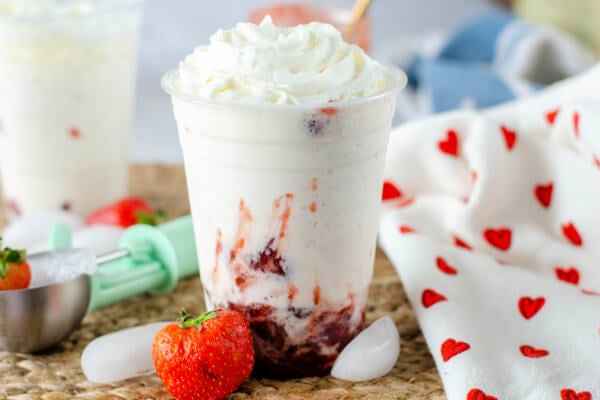 strawberries frappucino on table with towel and fresh ripe strawberries