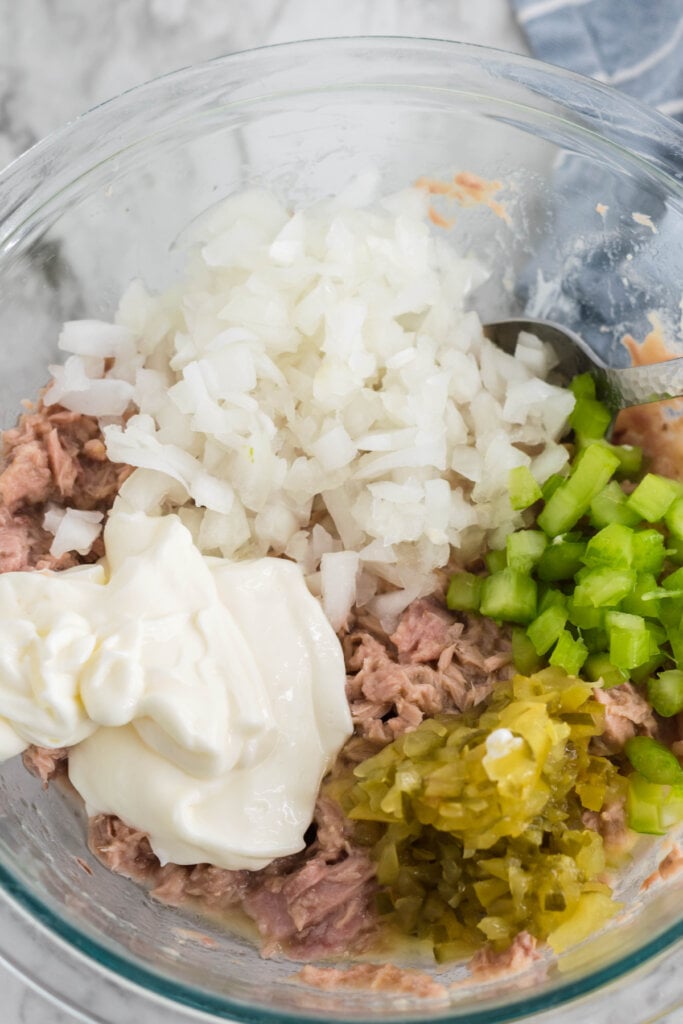 tuna salad ingredients in bowl before being mixed