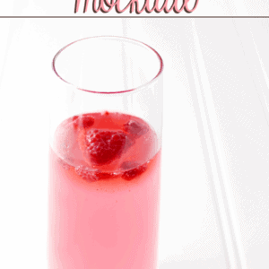 Drink Pink Mocktail in a glass with fresh strawberries.